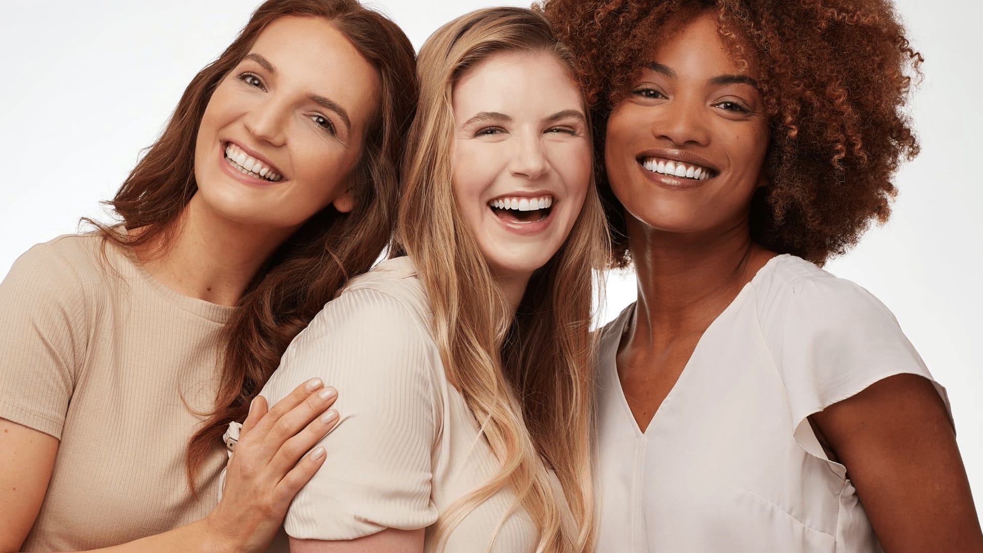 3 happy women standing close together