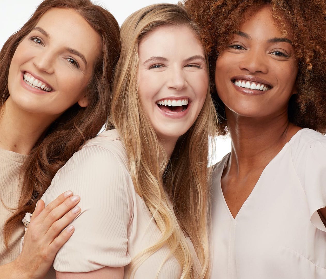3 happy women standing close together